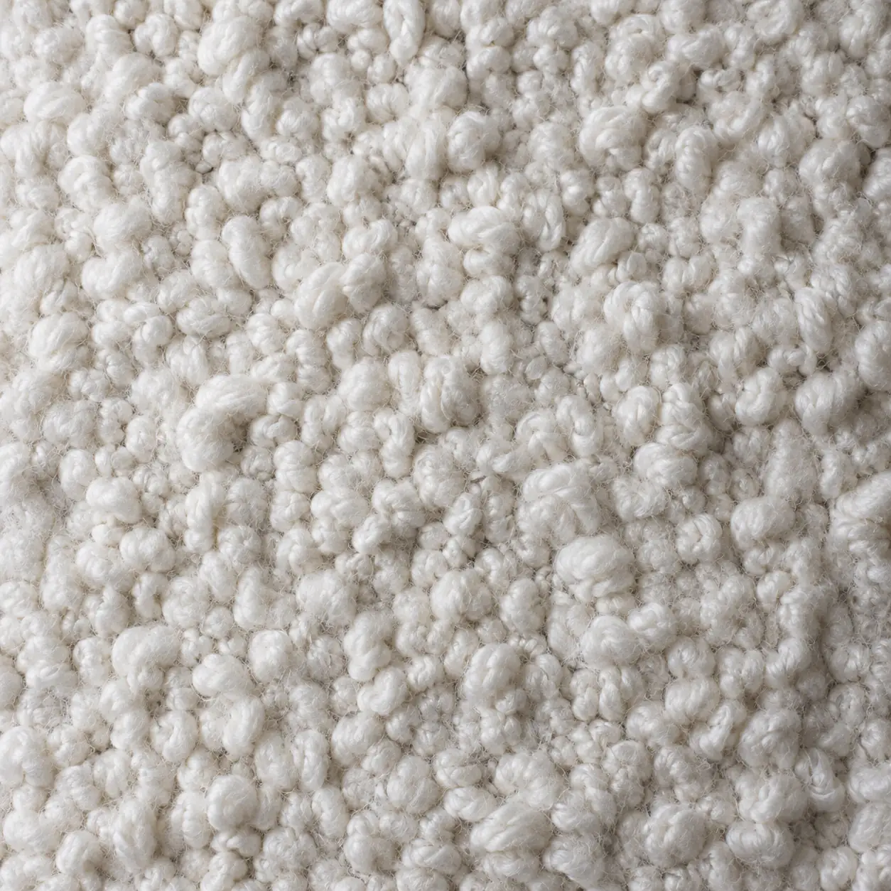 Close detail of chalk bouclé, looped and shadowed